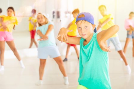Boys and girls dancing cool hip-hop dance during their rehearsal.