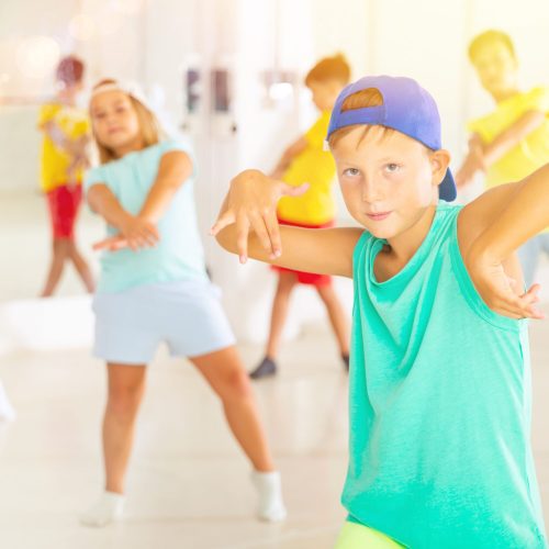Boys and girls dancing cool hip-hop dance during their rehearsal.